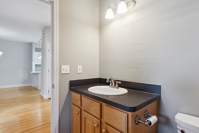 bathroom featuring vanity, toilet, and wood-type flooring