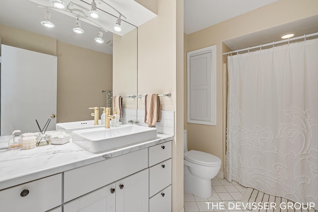 bathroom featuring tile patterned flooring, vanity, and toilet