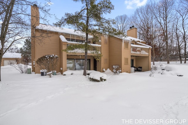 snow covered property featuring a deck