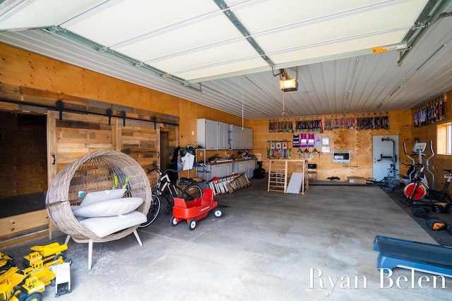 garage featuring a garage door opener and a workshop area