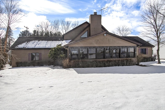 view of snow covered back of property