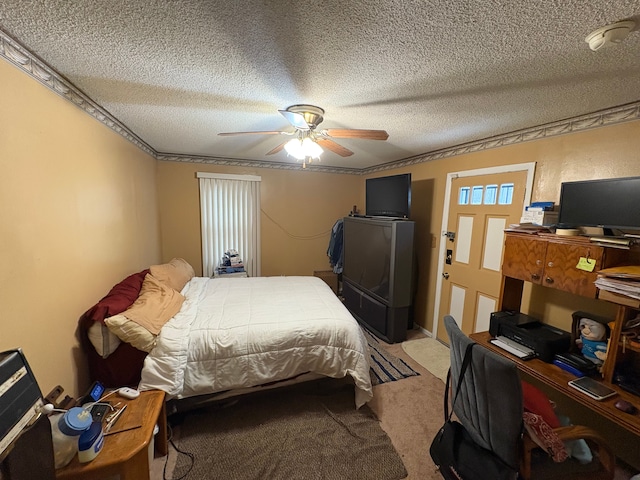 carpeted bedroom with ceiling fan, ornamental molding, and a textured ceiling