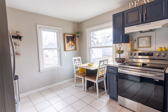 kitchen featuring light tile patterned floors, blue cabinetry, a healthy amount of sunlight, and appliances with stainless steel finishes