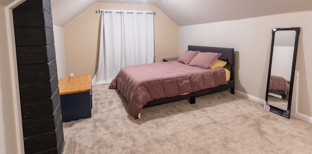 bedroom with light colored carpet and lofted ceiling