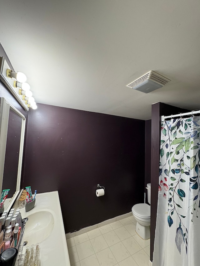 bathroom featuring tile patterned floors, vanity, and toilet