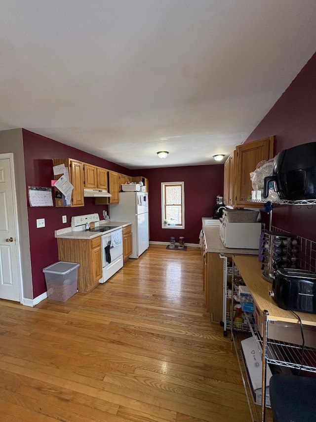 kitchen with white appliances and light wood-type flooring