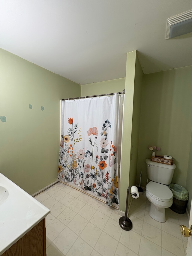 bathroom featuring vanity, toilet, and a shower with shower curtain