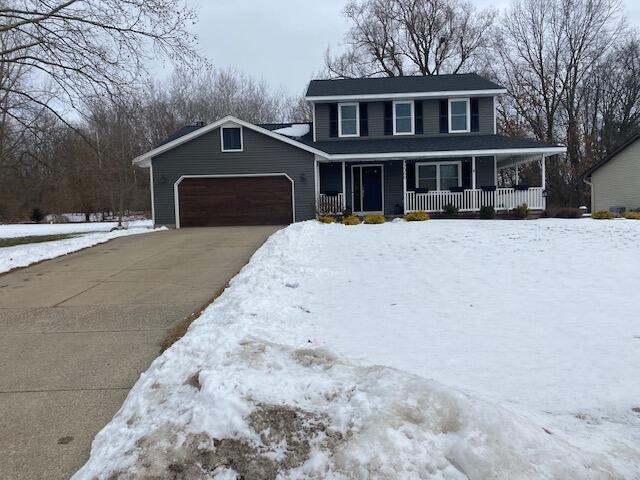 view of front facade featuring a garage and covered porch