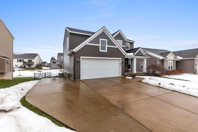 view of front of property featuring a garage and central air condition unit