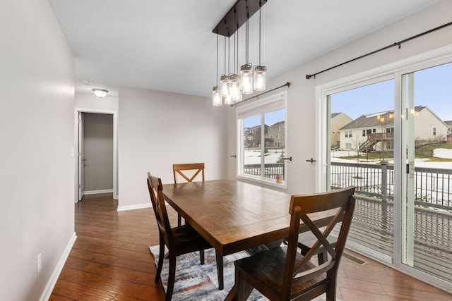 dining room featuring dark hardwood / wood-style flooring and a notable chandelier