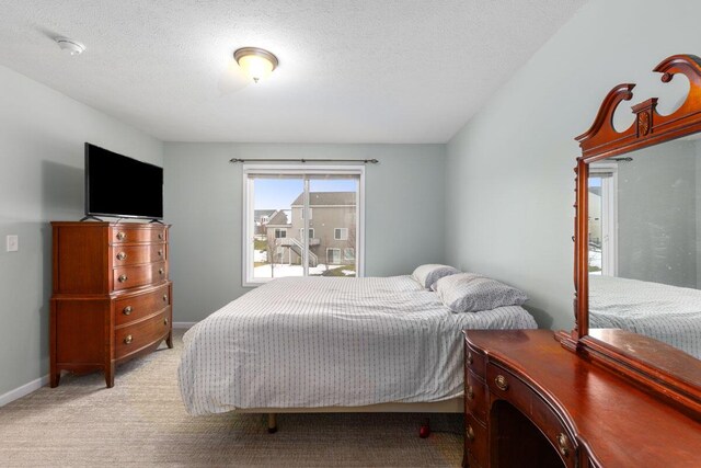 carpeted bedroom featuring a textured ceiling