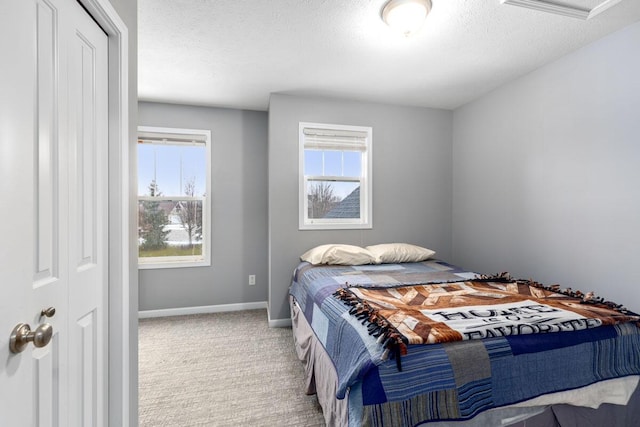 bedroom with light carpet and a textured ceiling