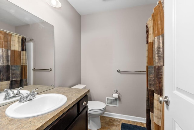 bathroom featuring vanity, a shower with shower curtain, and toilet