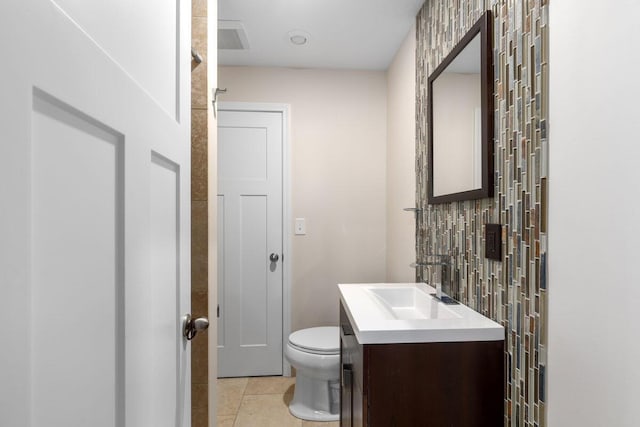 bathroom with tile patterned flooring, vanity, and toilet