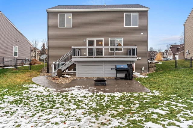 snow covered property featuring a yard and a deck