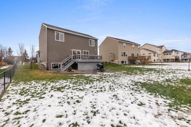 snow covered property with a deck