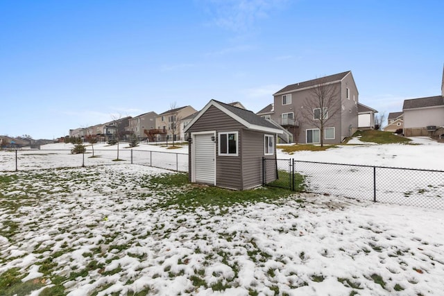 yard layered in snow with a storage unit