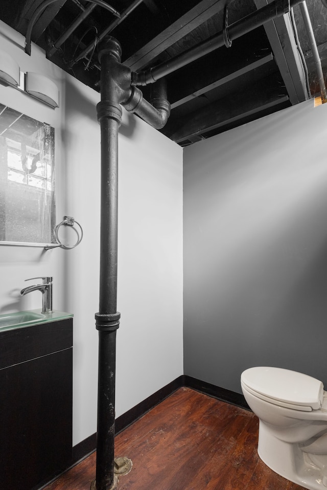 bathroom with wood-type flooring, sink, and toilet