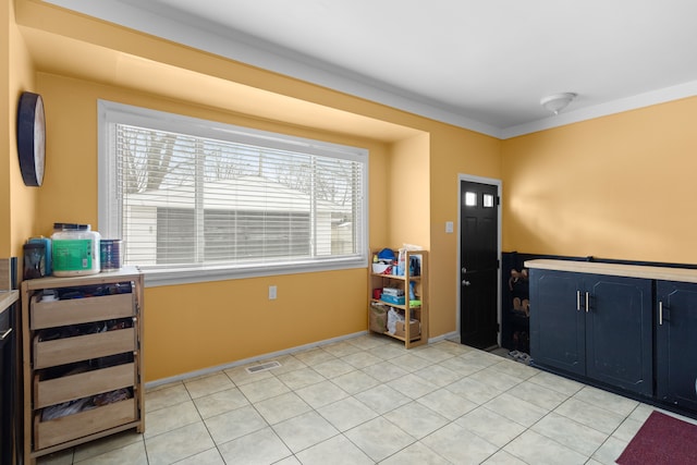 foyer featuring light tile patterned floors and beverage cooler