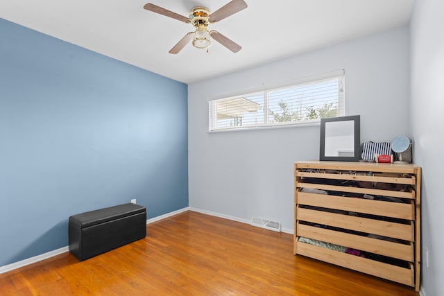 bedroom with ceiling fan and hardwood / wood-style floors