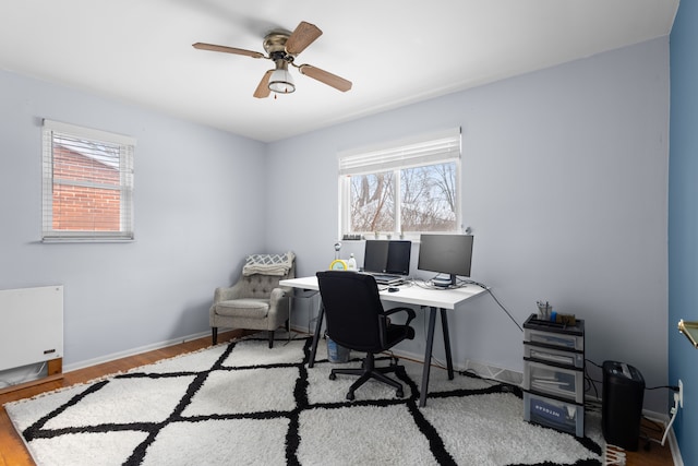 home office with ceiling fan and light wood-type flooring