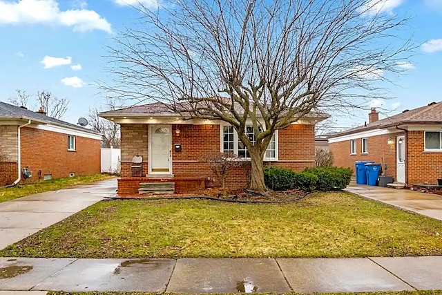 bungalow-style home with a front yard