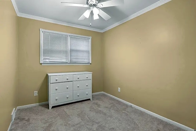 unfurnished bedroom featuring crown molding, light colored carpet, and ceiling fan