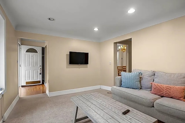 living room featuring light carpet and a chandelier