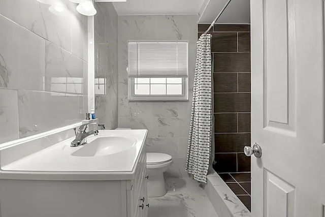 bathroom with vanity, toilet, curtained shower, and tile walls