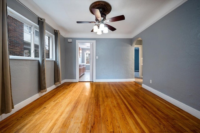 spare room featuring ceiling fan and light hardwood / wood-style flooring