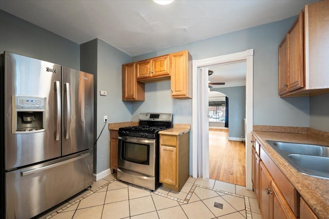 kitchen with light tile patterned flooring, stainless steel appliances, and sink