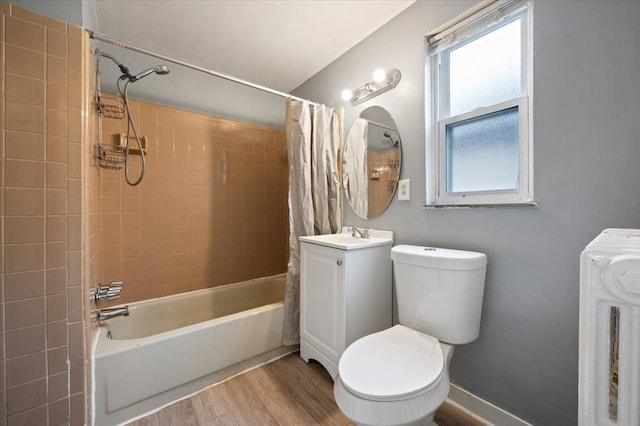 full bathroom featuring hardwood / wood-style flooring, shower / bath combo, vanity, and toilet