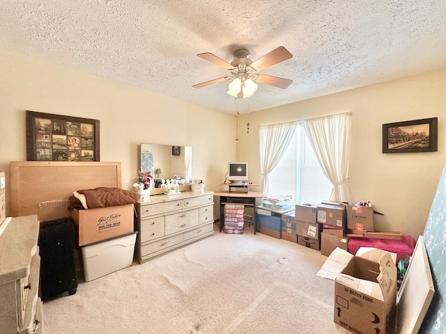 interior space featuring a textured ceiling, light colored carpet, and ceiling fan