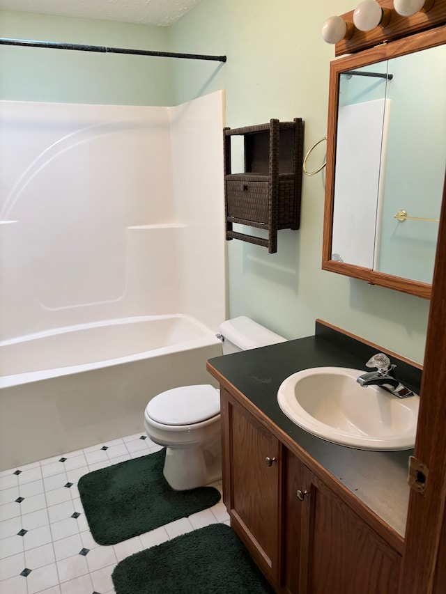 bathroom featuring tile patterned floors, vanity, toilet, and shower / bathtub combination