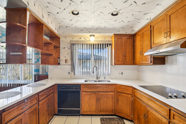 kitchen with a healthy amount of sunlight, black electric stovetop, sink, and light tile patterned floors