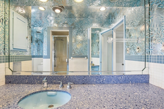 bathroom featuring vanity, a shower, and toilet