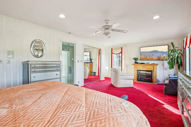 carpeted bedroom with ceiling fan and ensuite bath