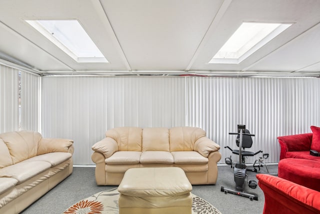 living room featuring lofted ceiling with skylight and carpet flooring