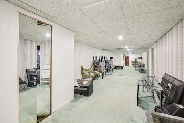 interior space with a paneled ceiling and concrete floors