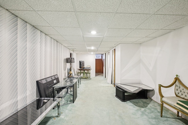 interior space featuring a paneled ceiling and carpet