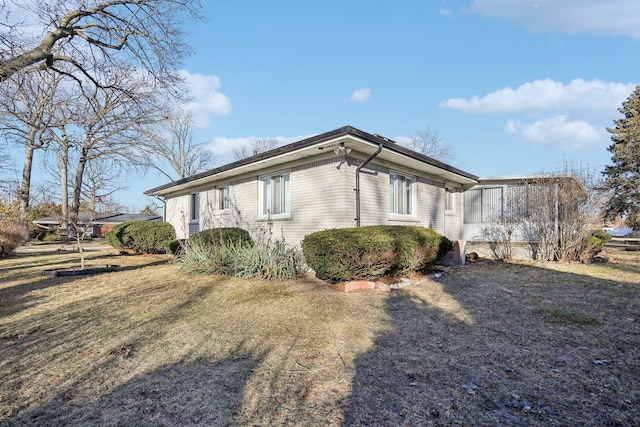 view of property exterior featuring a lawn