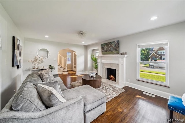 living room featuring dark hardwood / wood-style floors and a fireplace