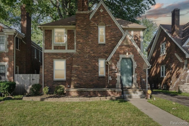 tudor-style house with a lawn