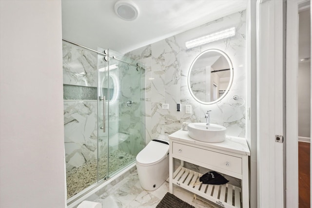 bathroom featuring vanity, a shower with shower door, and toilet