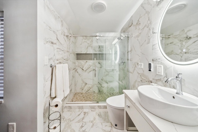 bathroom featuring vanity, a shower with shower door, and toilet