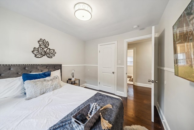 bedroom with dark wood-type flooring