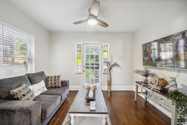 living room featuring dark hardwood / wood-style floors and ceiling fan