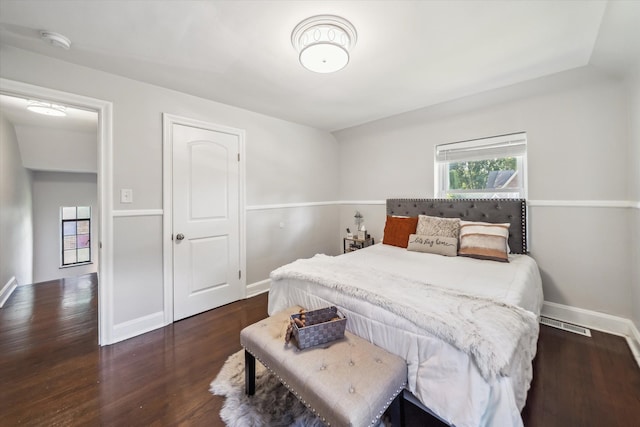 bedroom with dark hardwood / wood-style floors