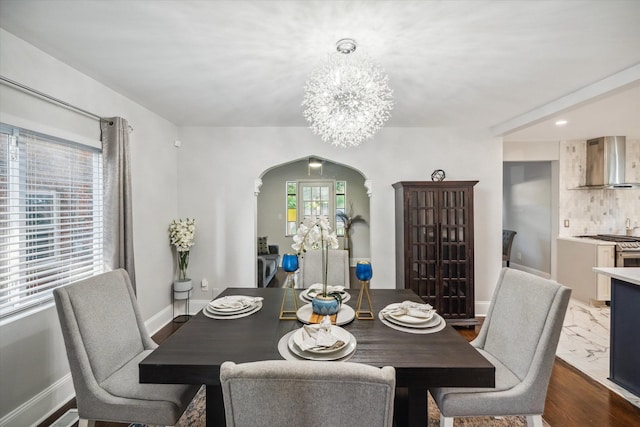 dining room featuring dark hardwood / wood-style flooring and a chandelier