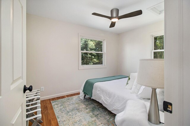 bedroom with ceiling fan and dark hardwood / wood-style floors